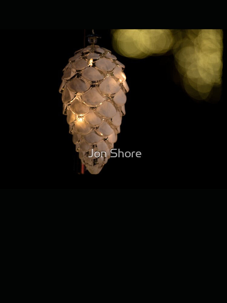 Shiny Christmas Light Pine Cone in a Dark Background by Jon Shore